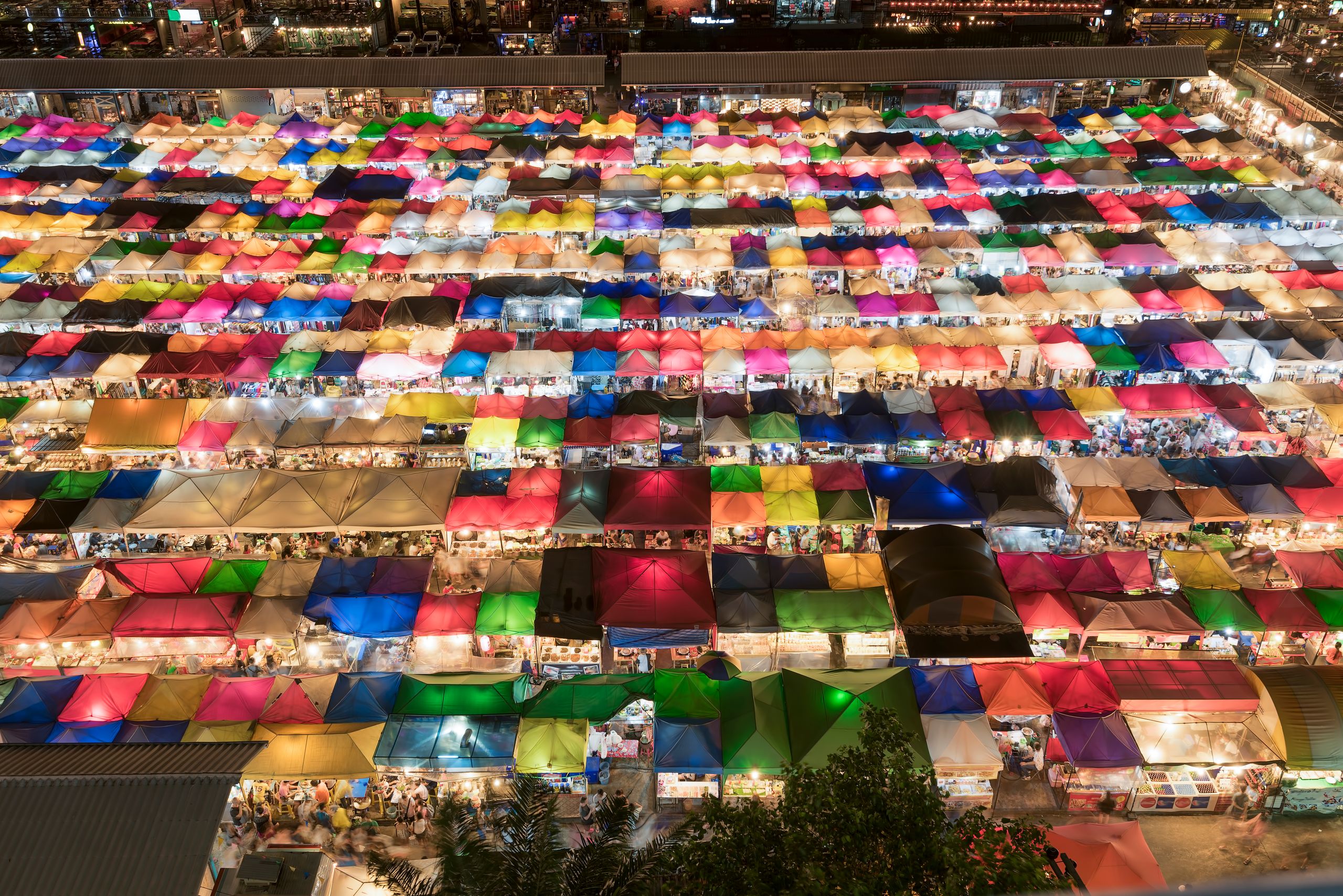 aerial view of a large market with persony colorful tents Talad Neon Night Market